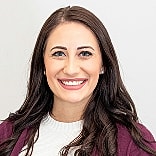 Smiling woman with long dark hair.