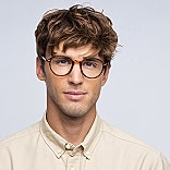 Young man with glasses and casual attire.