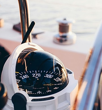 Boat compass on a yacht dashboard.