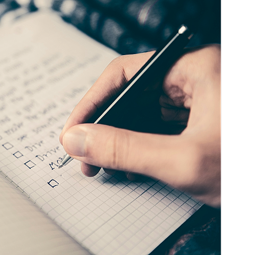Hand ticking off items on a checklist.